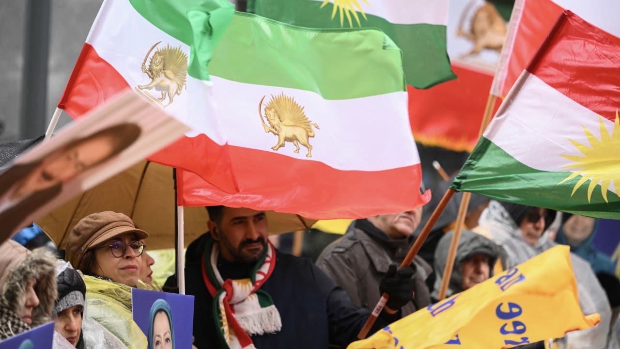 Historical Iranian imperial flag flying on a pole